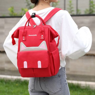 sac a dos a langer catlyn rouge porté dans dos par maman